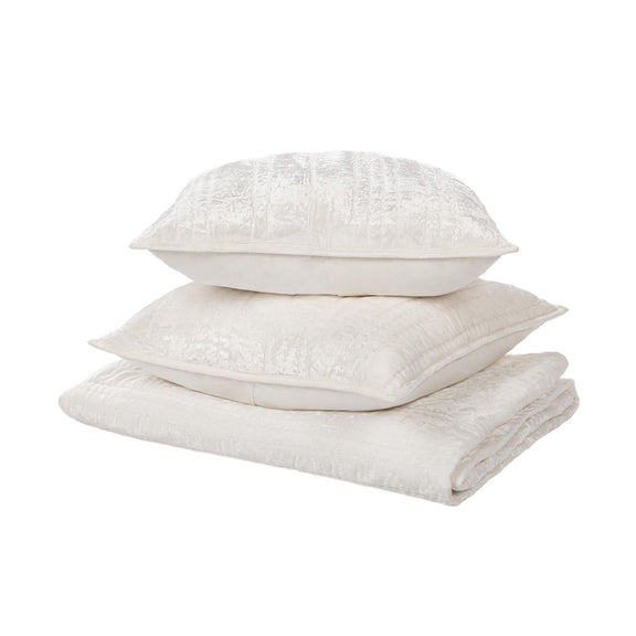 White quilted pillow shams stacked, with subtle texture and stitched edges