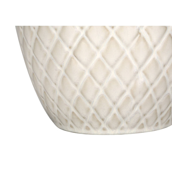 Close-up of cream textured ceramic lamp base with diamond lattice pattern