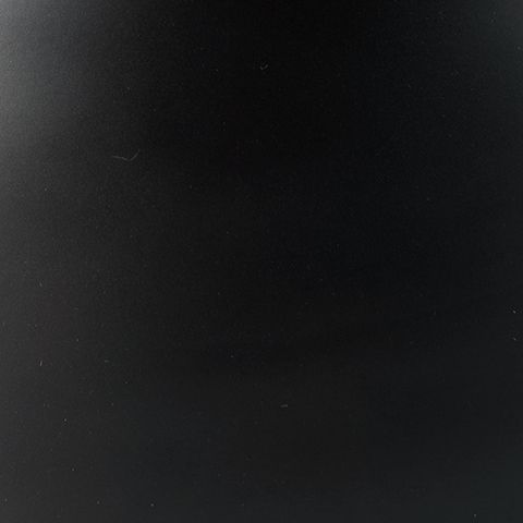 Bronze-finished tabletop surface with dark matte look, close-up