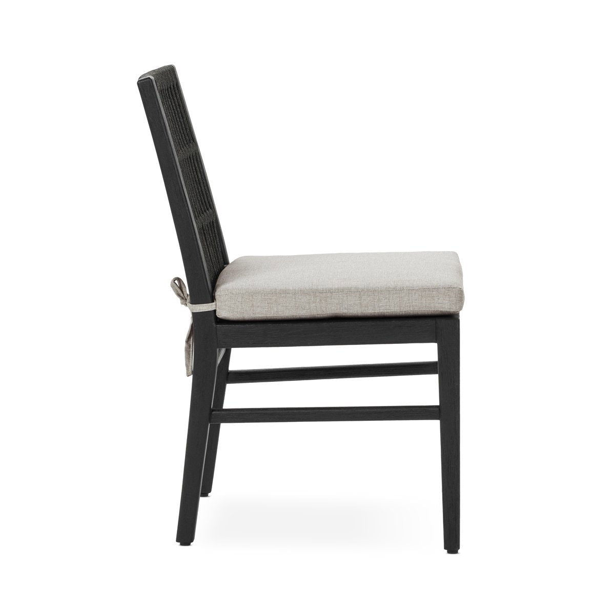 Black outdoor dining chair with slatted back and beige seat cushion, side view