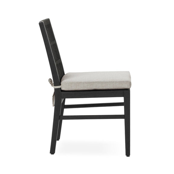 Black outdoor dining chair with slatted back and beige seat cushion, side view