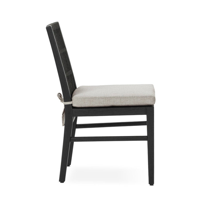 Black outdoor dining chair with slatted back and beige seat cushion, side view
