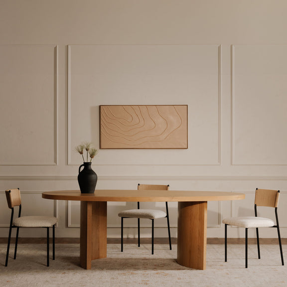 Foley dining chairs with white seats, woven tan backs, and black frames around a table