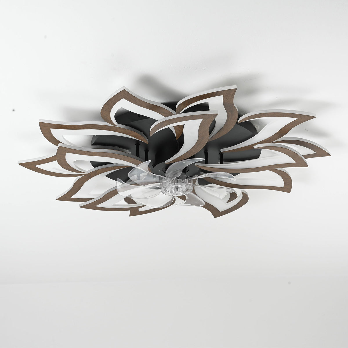 Flush mount ceiling fan with leaf blades, metallic housing, and clear light diffuser
