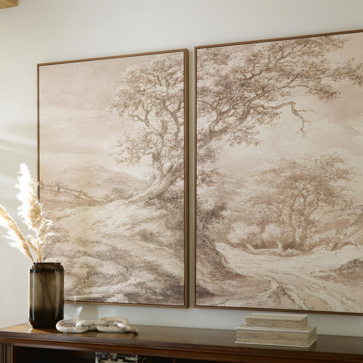 Two framed beige and brown landscape prints featuring detailed tree branches