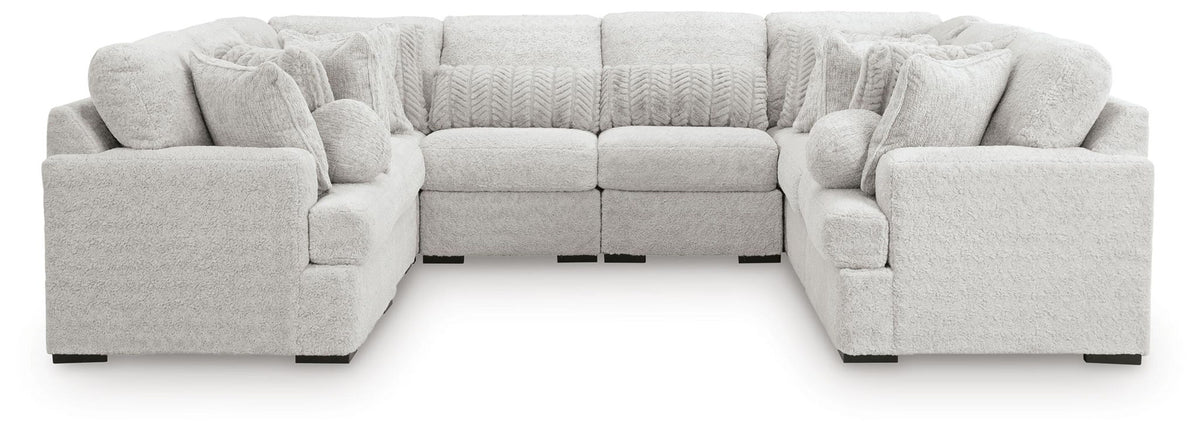 White plush sectional sofa with two corner ottomans and rounded arms