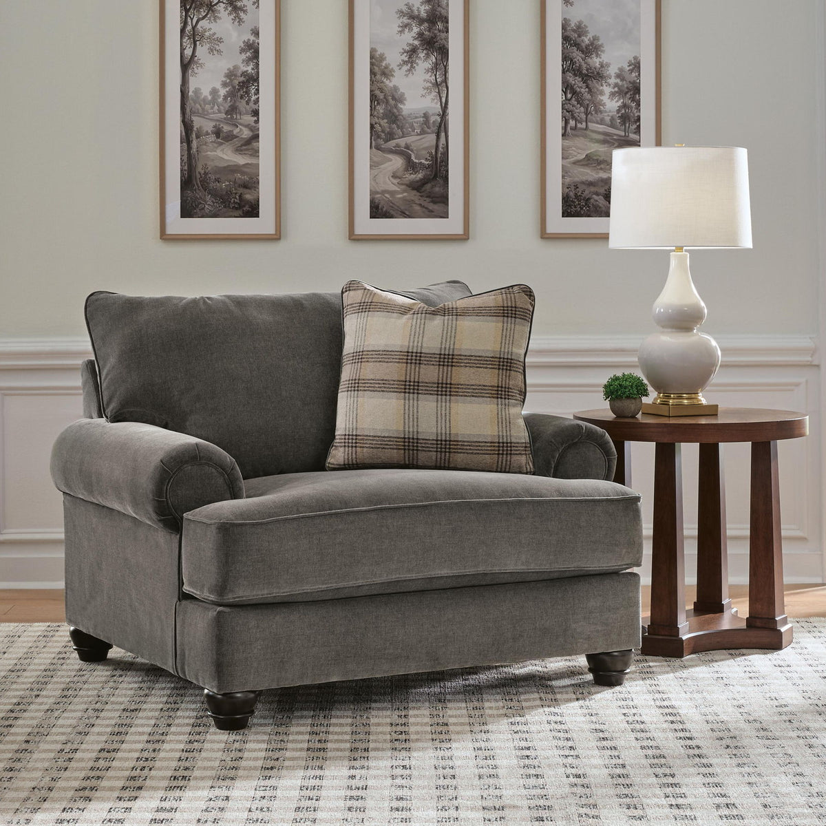 Shadow gray chair and a half with plaid lumbar pillow and padded armrests
