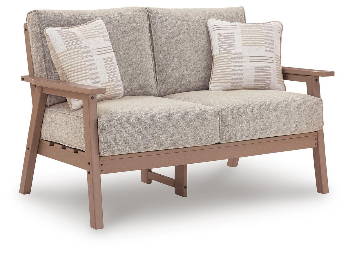 Outdoor loveseat angled view with light gray seat cushion and driftwood frame, plus two pillows
