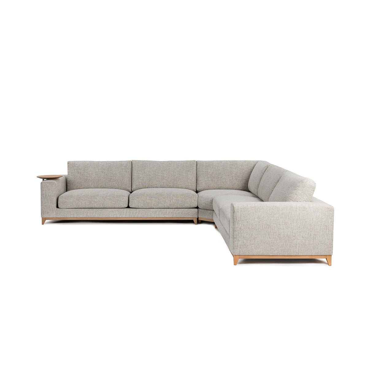 Light sand sectional sofa with chaise end and back cushions; visible wood legs.