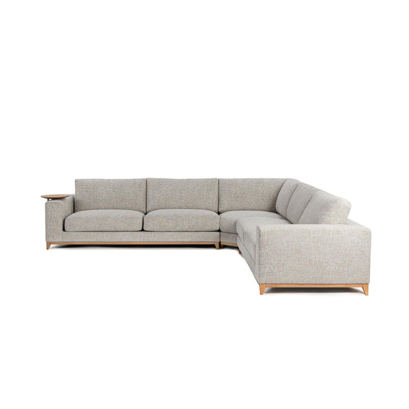 Light sand sectional sofa with chaise end and back cushions; visible wood legs.