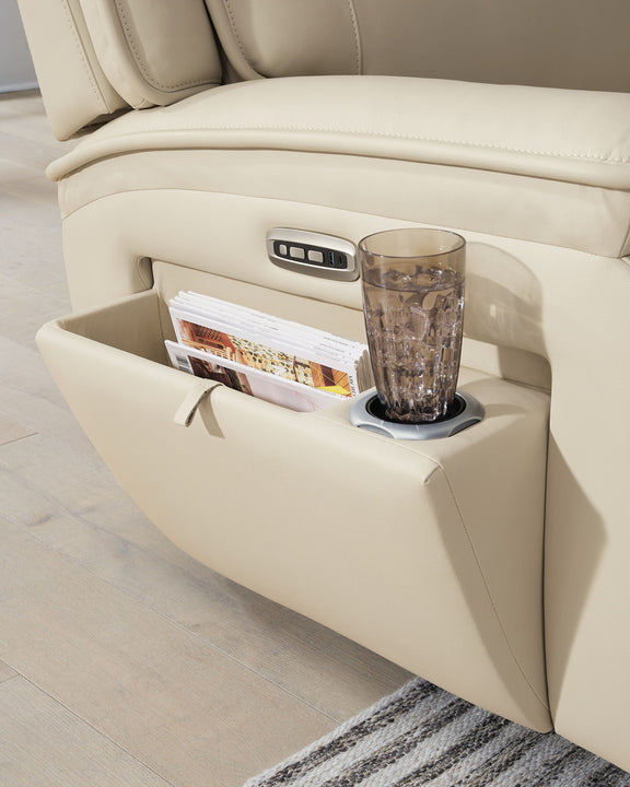 Beige sectional console with cup holder and storage pocket beside recline seat.