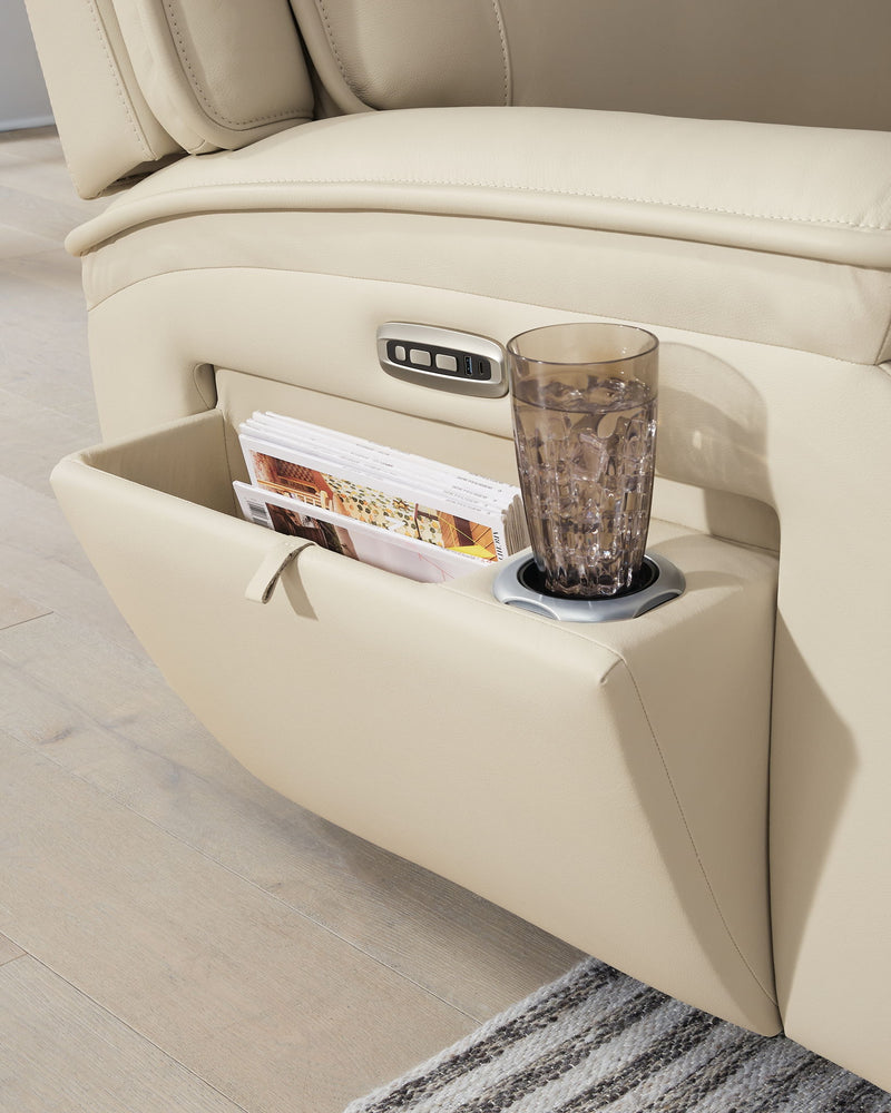 Beige sectional console with cup holder and storage pocket beside recline seat.