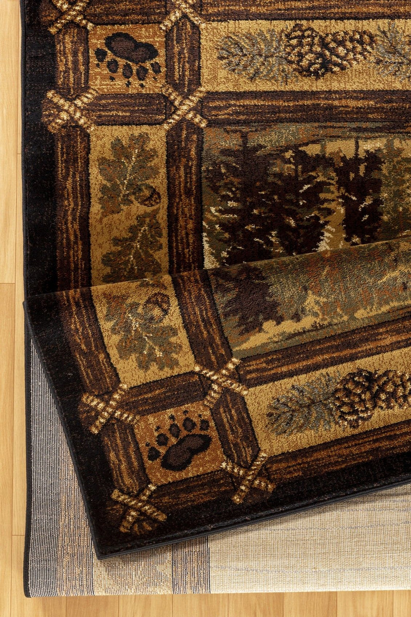 Corner of lodge area rug, dark geometric border and pine-tree scene on cream