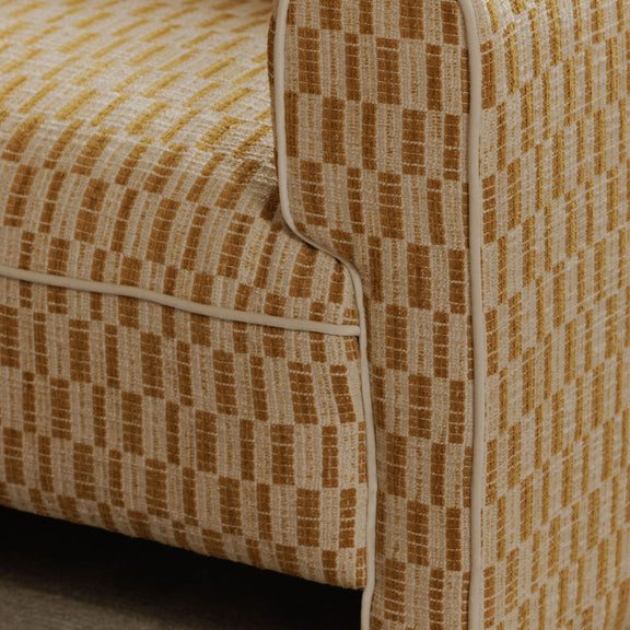 Close-up of chartreuse and beige woven fabric on accent chair arm and seat