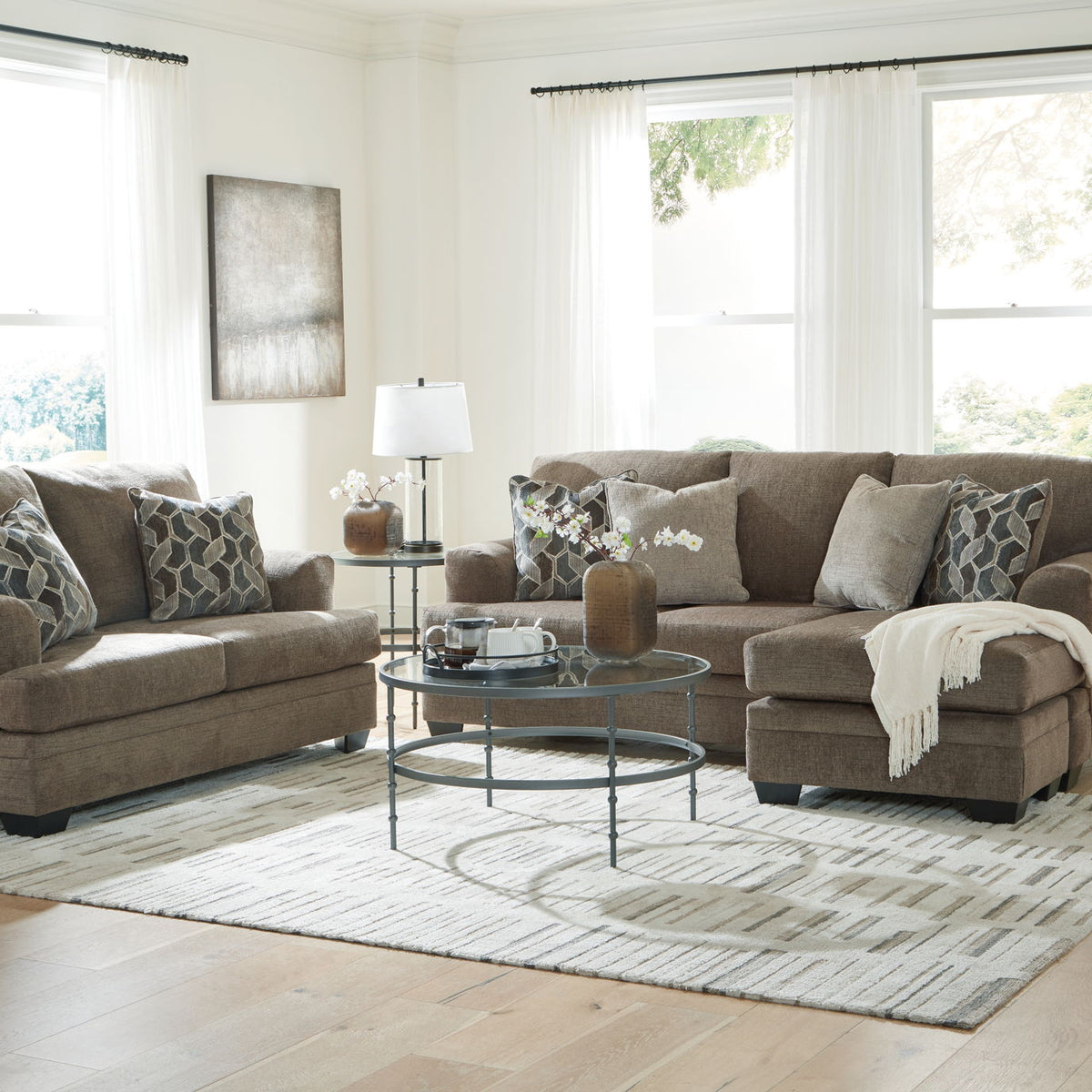 Living room sectional sofa set with chaise and ottoman-style seating, plus patterned pillows