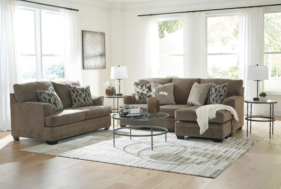 Living room sectional sofa set with chaise and ottoman-style seating, plus patterned pillows