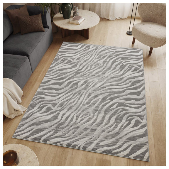 Gray geometric wave rug on wood floor with wavy stripe design