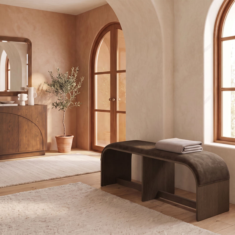 Velvet upholstered bench with dark gray seat and wooden base, side view