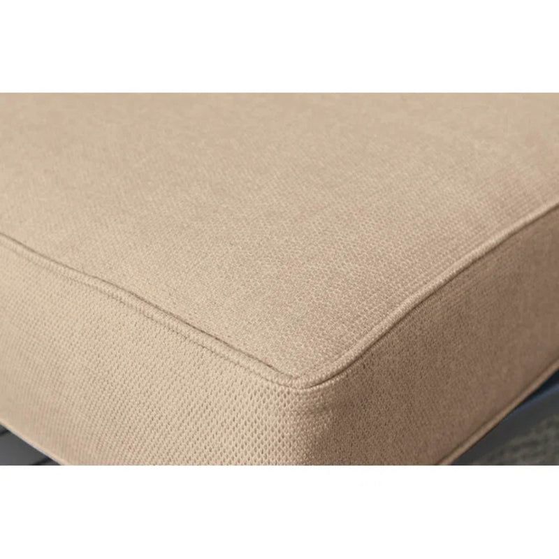 Beige cushion corner with stitched seam on a rattan sectional seat