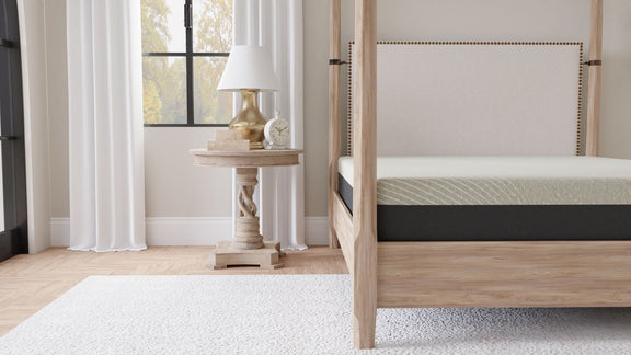 Gray tight-top gel memory foam mattress corner view on wood bed frame