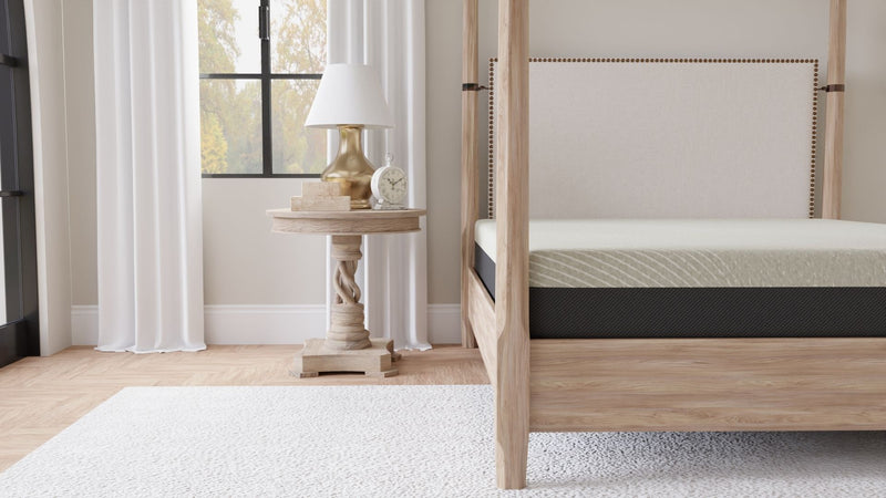 Gray tight-top gel memory foam mattress corner view on wood bed frame
