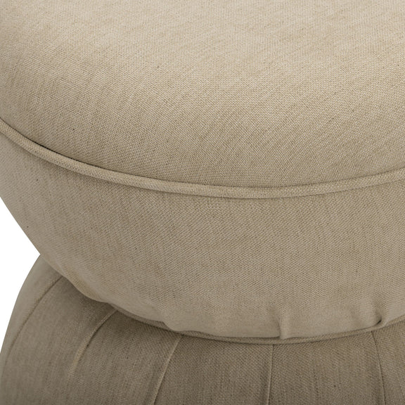 Close-up of beige ruched upholstered ottoman top with stitched seam