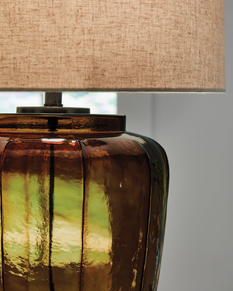 Amber glass table lamp body close-up with black top and socket