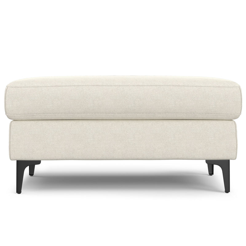 Cream upholstered ottoman with a cushioned top and black legs, shown from the front.
