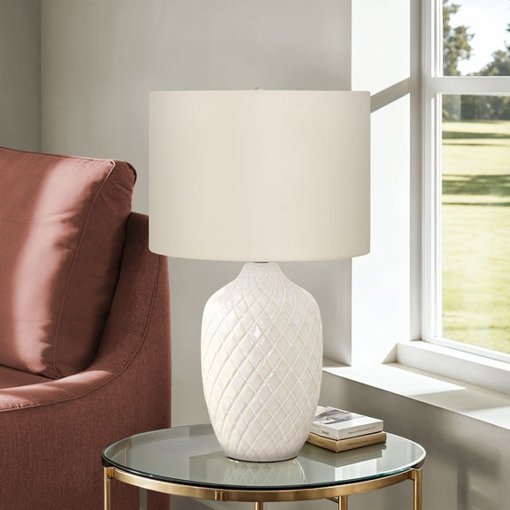 Cream table lamp with white drum shade and diamond-textured ceramic base on round top