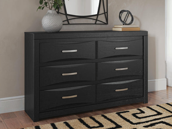 Black six-drawer dresser with mirror; six bar pull handles on drawer fronts.