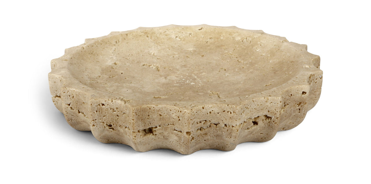 Beige travertine bowl with speckled texture and shallow curved rim.
