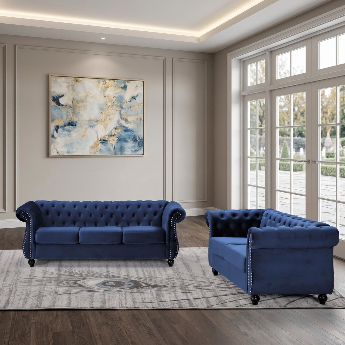 Blue three-seat button-tufted sofa with rolled arms, tufted cushions and studs