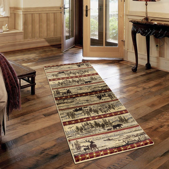 Beige lodge area rug runner on wood floor, wildlife and landscape pattern with red trim