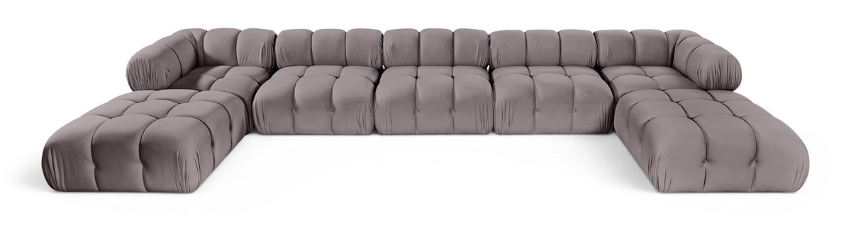 Gray modular sectional sofa with tufted seat panels and rounded armrests, sectional layout