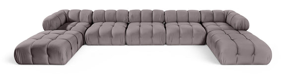 Gray modular sectional sofa with tufted seat panels and rounded armrests, sectional layout