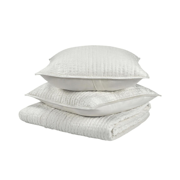 Light velvet quilt set with folded quilt and two matching decorative pillows