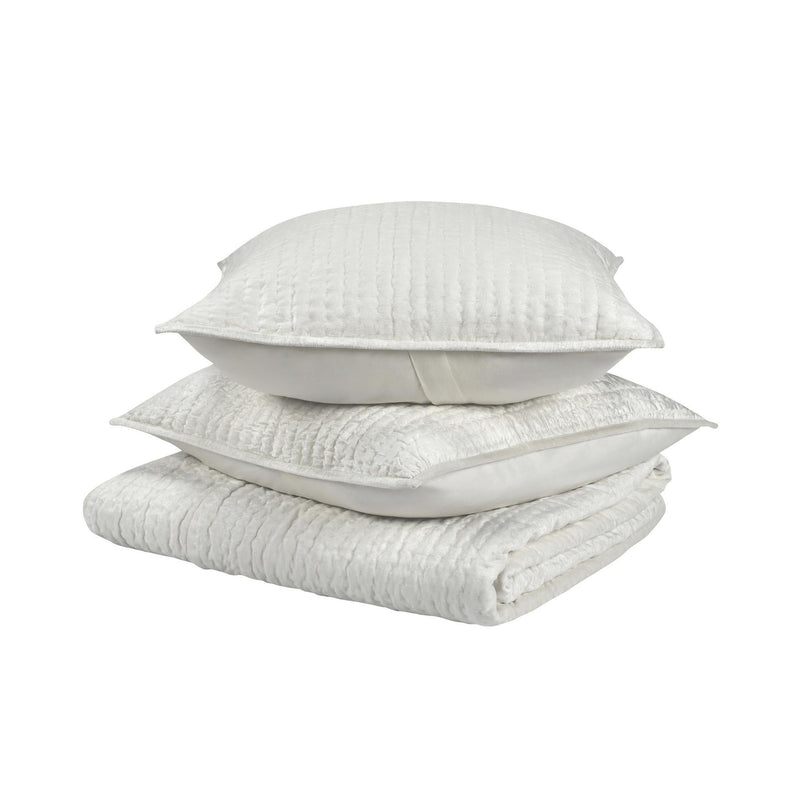 Light velvet quilt set with folded quilt and two matching decorative pillows