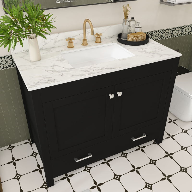 Black bathroom vanity cabinet with white sink, faucet holes, and two doors with pulls