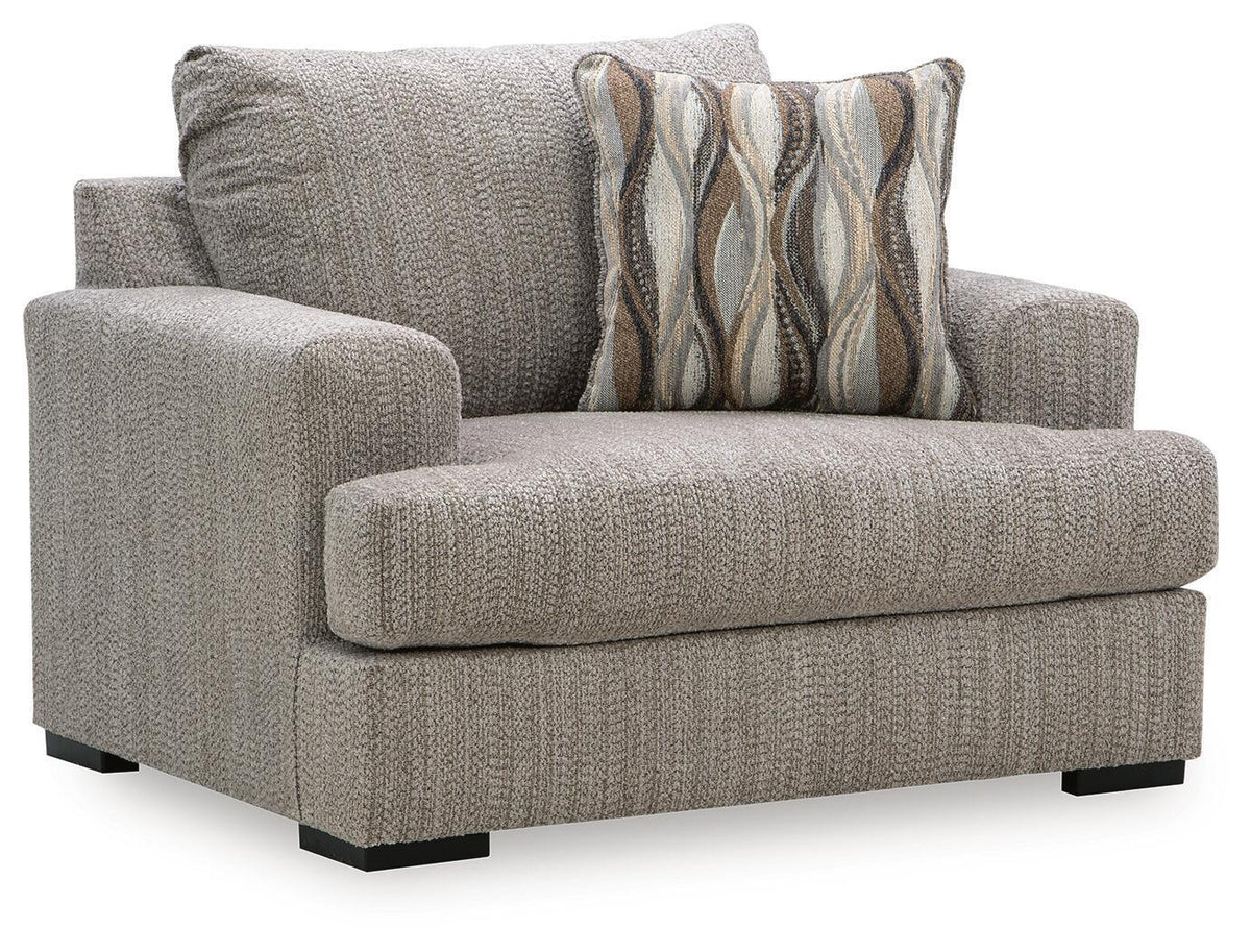 Gray chair and a half with textured fabric, wide arms, and striped accent pillow