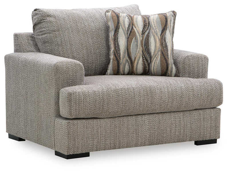Gray chair and a half with textured fabric, wide arms, and striped accent pillow