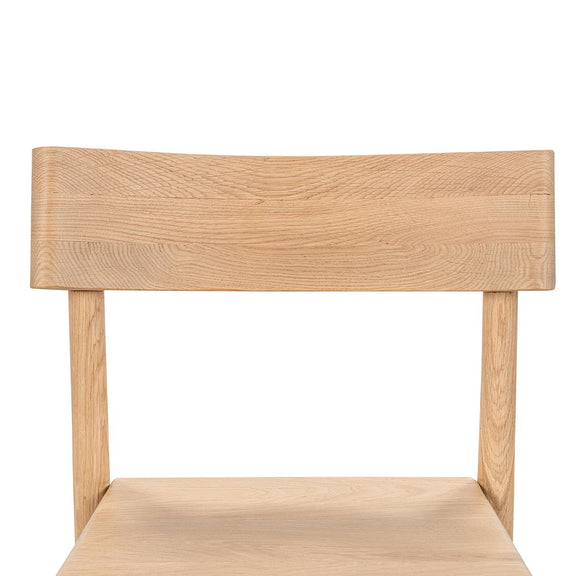 Light oak counter stool close-up of backrest and seat, smooth wood grain finish
