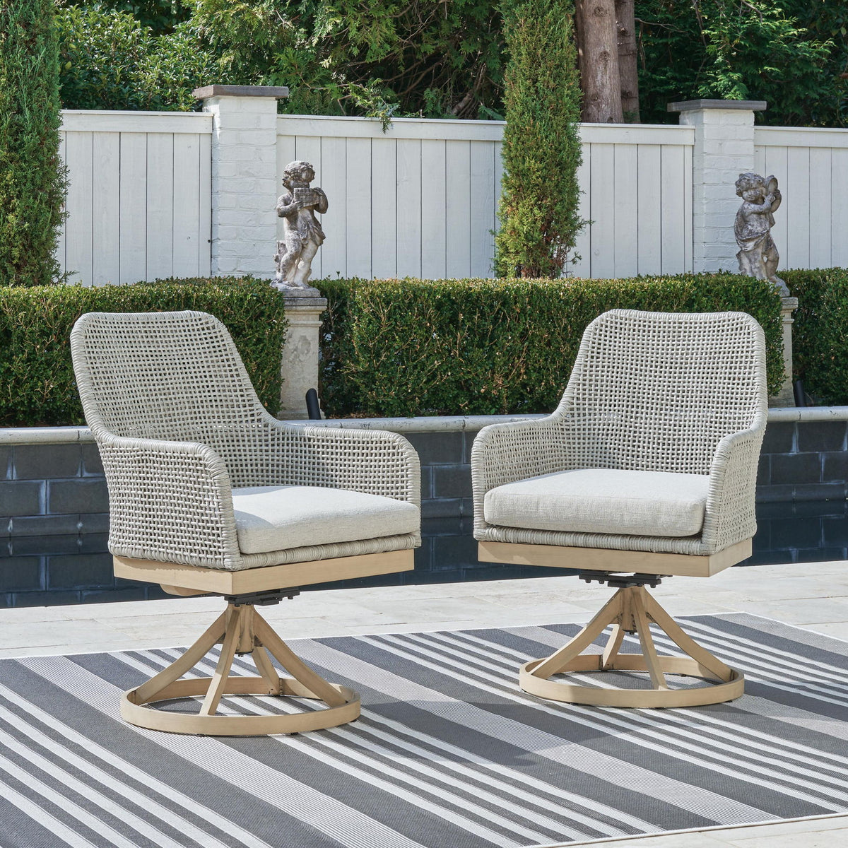 Set of 2 gray woven swivel chairs with white cushions and round bases