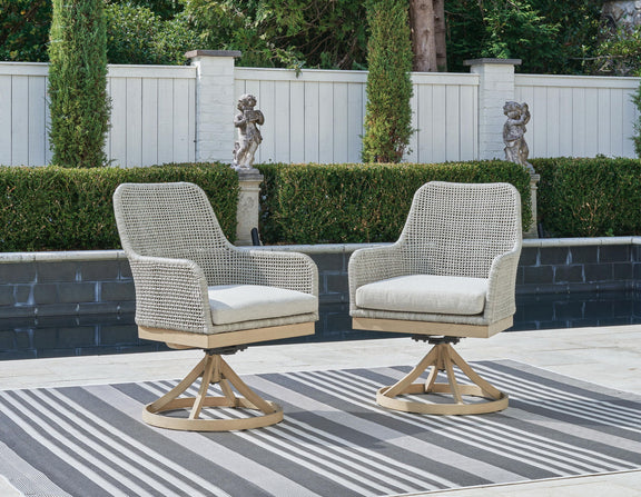 Set of 2 gray woven swivel chairs with white cushions and round bases