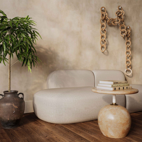 Beige faux marble round side table with short rose-gold stem and globe base