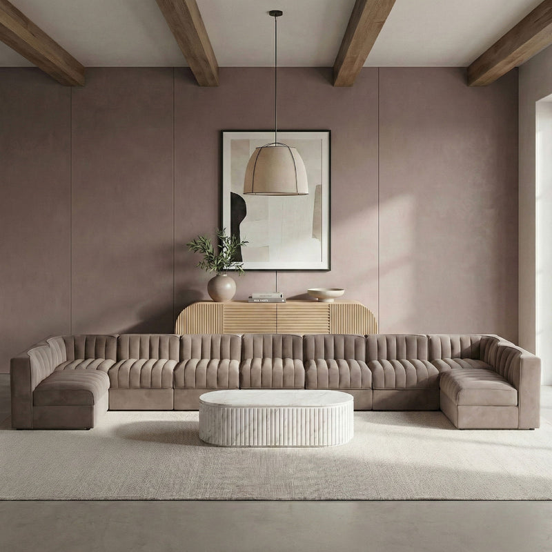 Dark gray armless velvet modular sectional with tufted back cushions and low ottoman-style seats