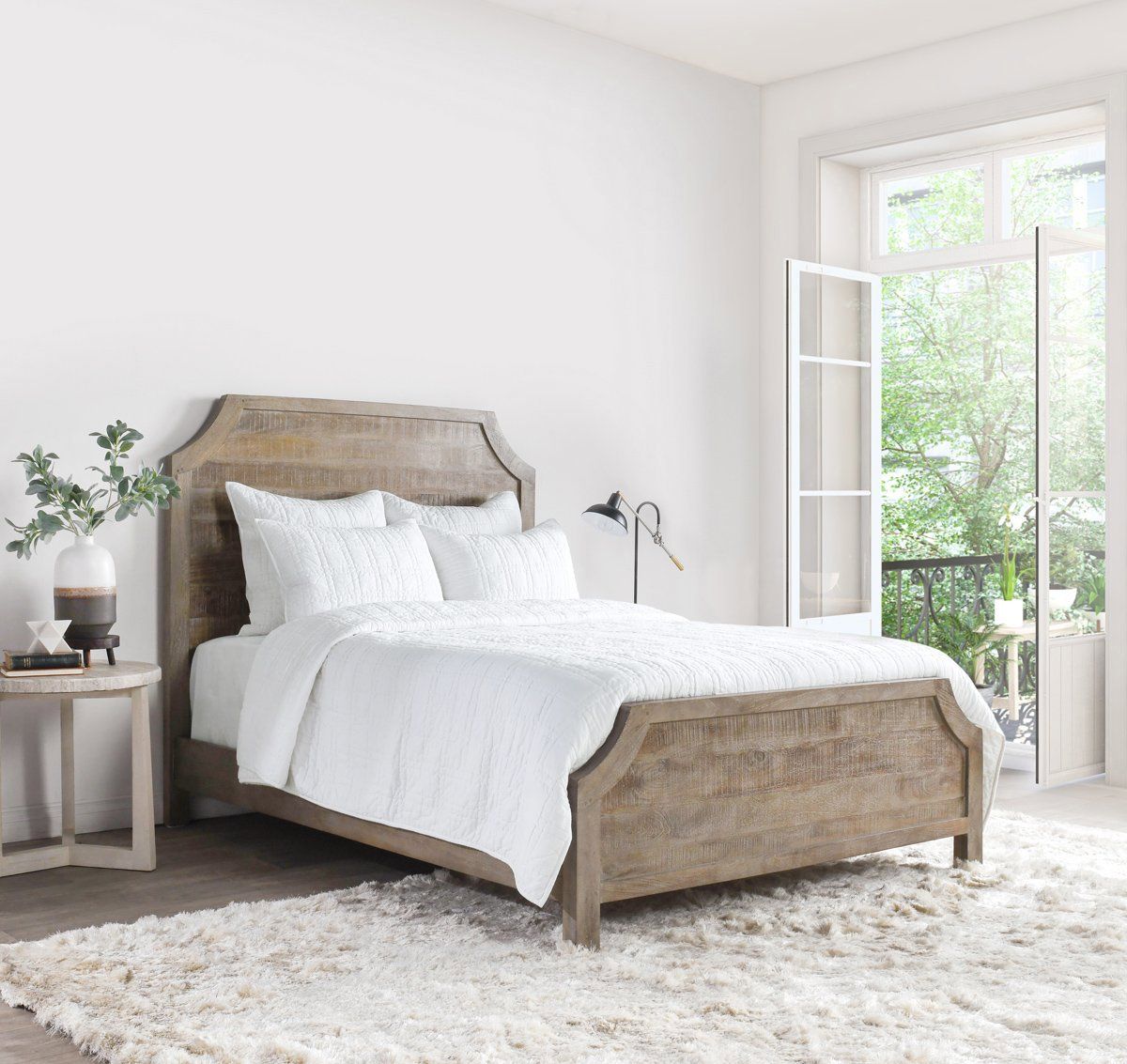 White quilt layered on bed with channel pattern and coordinated shams