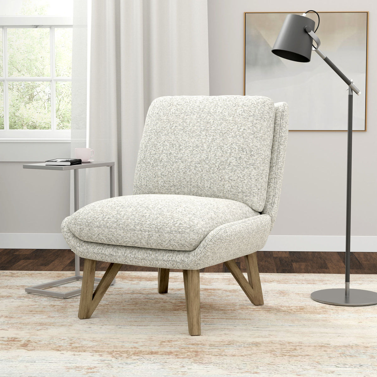 White speckled armless accent chair with padded back and seat, and angled wooden legs.