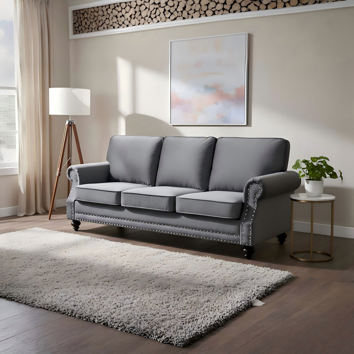 Dark gray 3-seat sofa with nailhead trim and turned legs, in living room