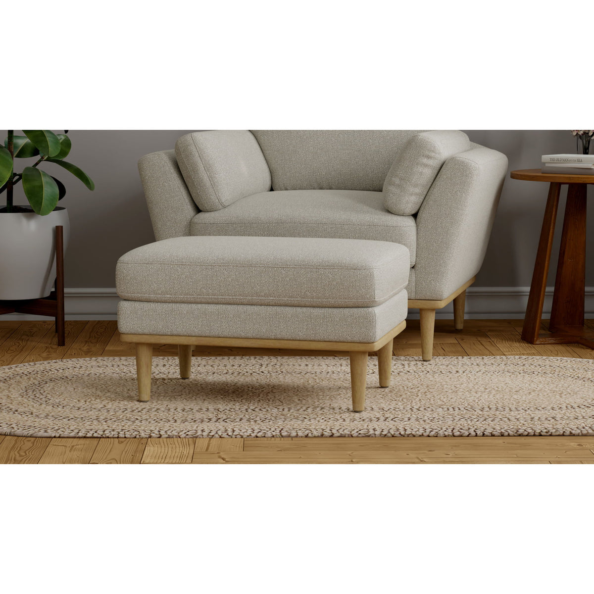 Tan chair ottoman with upholstered seat, side bolsters, and wooden legs.