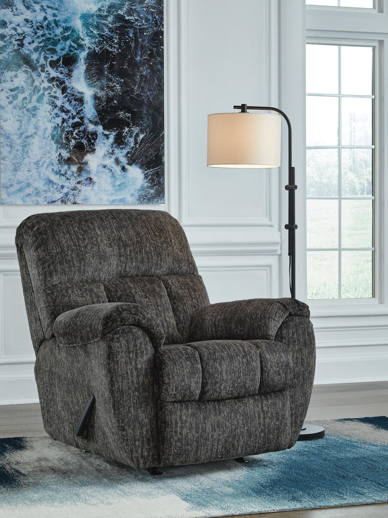 Dark gray rocker recliner chair with padded arms and cushioned backrest